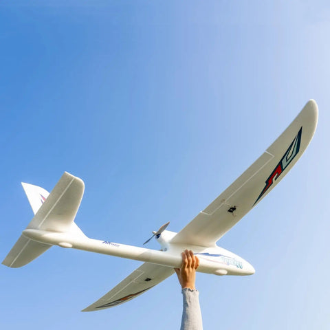 Person holding Prodigy 1400mm Wingspan RC Plane With Vector Flight Stabilization System 4 Channel Remote Control Airplane Ready To Fly