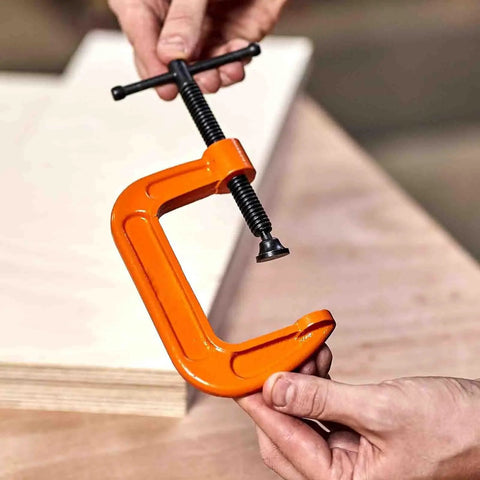 Beefy 1 Inch Heavy Duty Cast Iron G Clamp Quick Release For Woodworking And Welding Projects, Rugged Steel Clamp Fixture For Assembly, DIY Workshop, Hand Tool, Adjustable Screw, Non Slip Grip, High Load Capacity, orange G clamp held by hands