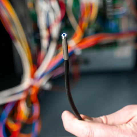 Close-up of Rugged Utility Borescope Endoscope Camera With 9.8 Ft Waterproof Gooseneck 5.5 mm Insertion Tube held by hand.