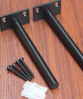 Two 6 inch black solid steel floating shelf brackets with screws and plugs, part of 12 pack concealed shelf supports for floating wood shelves.