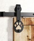 Close-up of black rustic non bypass sliding barn door hardware kit for one door with 4 foot flat track and puppy paw roller tough as nails