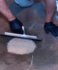 Applying Quick Setting Epoxy Concrete Floor Patch Two Gallon Light Gray Rapid Cure Mix to repair a concrete floor.