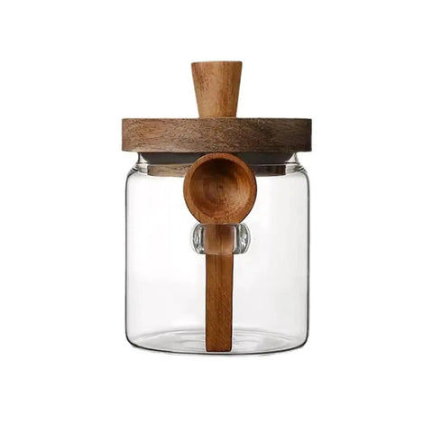 Go Ahead And Upgrade Your Countertop Setup With This Solid Clear Glass Storage Jar Featuring An Airtight Sealed Kitchen Canister And Wooden Spoon For Coffee Beans 900Ml Capacity Handles Dry Goods Smoothly And Looks Dope - front view with wooden lid and spoon.