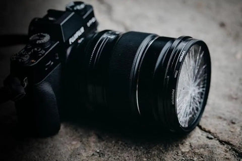 67mm UV Protection Filter for Camera Lens Keeps Your Gear Safe From Scratches Dust and Moisture on a black camera with cracked filter