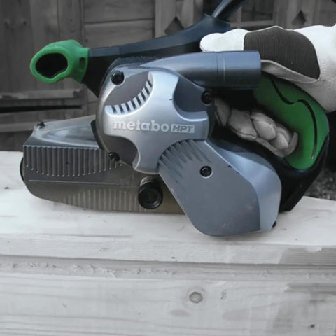 3 X 21 Inch Belt Sander For Woodworking With Variable Speed 9 Amp Motor Soft Grip Handle in use on wooden plank close-up view
