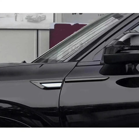 Glossy Side Fender Vents Trim Covers For Tesla Cybertruck shown on a black vehicle side panel, enhancing its sleek style.