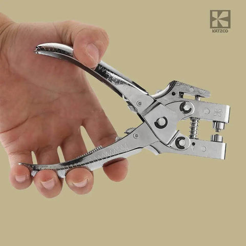 Hand holding All In One Grab And Go Eyelet Grommet Pliers Kit With 1 Hole Punch and 100 Gold Grommets for leather, canvas, and crafts