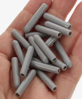 Top Shelf Gray Dishwasher Rack End Caps 50 Pack No Sweat Universal Prong Tip Covers Heavy Duty Plastic parts on a hand.