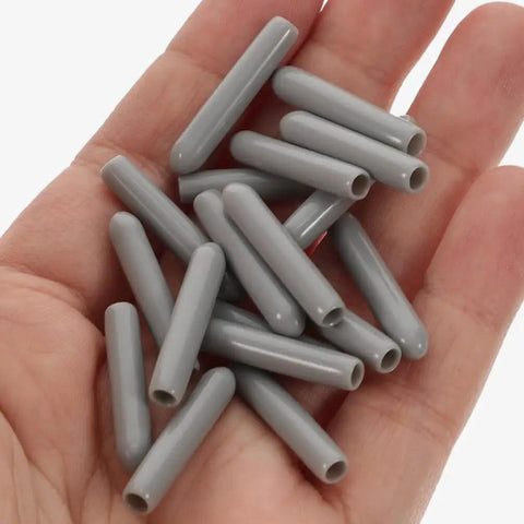 Top Shelf Gray Dishwasher Rack End Caps 50 Pack No Sweat Universal Prong Tip Covers Heavy Duty Plastic parts on a hand.
