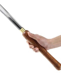 Dead Simple Wood Chisel Set Built Insanely Tough With High Carbon Steel Blades For Quick Wood Carving And Lathe Turning An Absolute Must Have Carpenter Gear Pack Kept Safe Inside A Classic Wooden Toolbox - close-up of chisel held in hand.