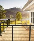 Heavy Duty Black Cable Railing Corner Post For Decks That Handles Any Outdoor Upgrade With Zero Sweat Surface Mount Install And Precision T Shaped Holes For 36 Inch Systems on a scenic deck.