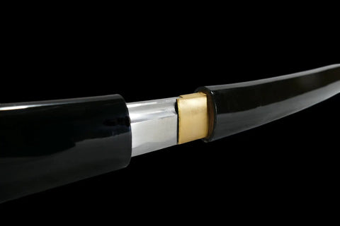Close-up of Hand Forged Shirasaya Style Samurai Katana Sword with razor sharp blade entering black scabbard, 39 inch length.