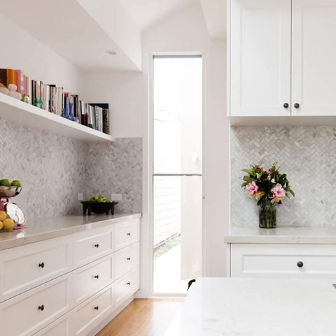 Stylish kitchen with white cabinets featuring black round cabinet knobs set of 50 pieces, 1.2 inch diameter, plastic drawer pulls.