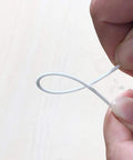 Person holding White PLA Filament 1.75mm 1kg for 3D Printing Tougher, Stronger FDM Material, showing flexibility.