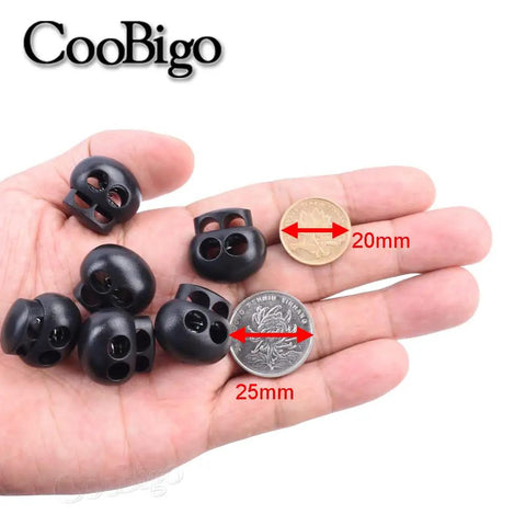 25 Pack Spring Cord Locks End Stops For Drawstrings And Shoelaces shown held in hand with size comparison to coins