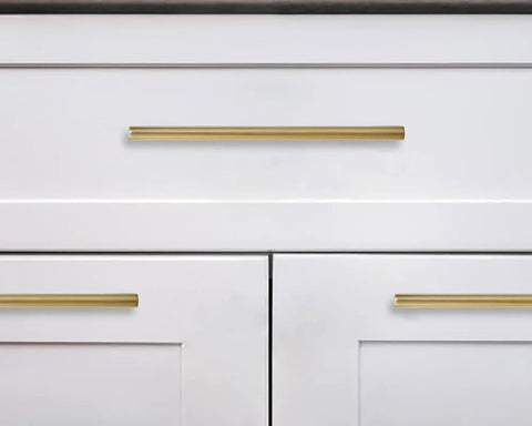 Six Pack 6 Inch Center To Center Brushed Brass Cabinet Pulls installed on white kitchen drawers