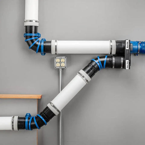 Articulating Dust Collection Fittings for 4 Inch Hose adjustable from straight to 90 degree installed on a wall with connectors