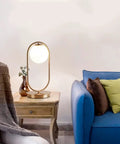 Dope Gold Globe Table Lamp With White Glass Shade For Bedside And Desk Mid Century Modern Style on wooden table by sofa