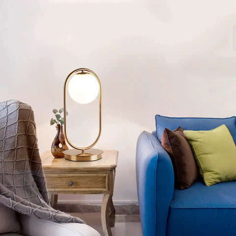 Dope Gold Globe Table Lamp With White Glass Shade For Bedside And Desk Mid Century Modern Style on wooden table by sofa