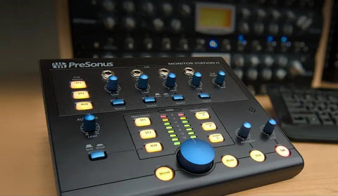 Beast Pro Desktop Studio Control Hub With Four Stereo Input Pairs And SPDIF Digital Input shown on wooden desk with controls visible