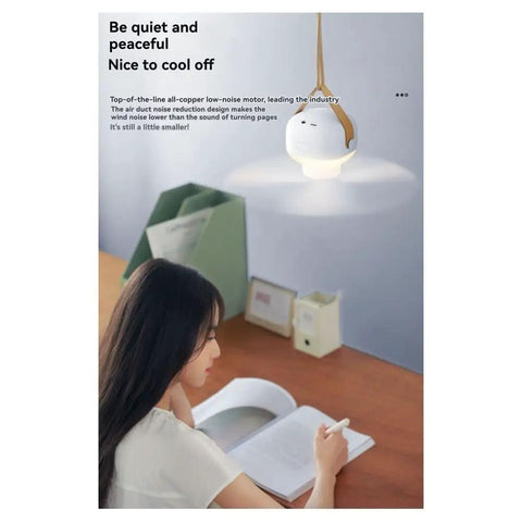 kousoer Ceiling Fans Quiet Remote USB 7200mAh hanging in a study setting, illuminating the workspace while a woman writes.