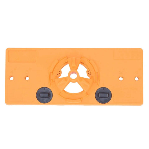 Front view of 35mm hinge hole jig base in orange plastic with central circular drilling guide and two black dials