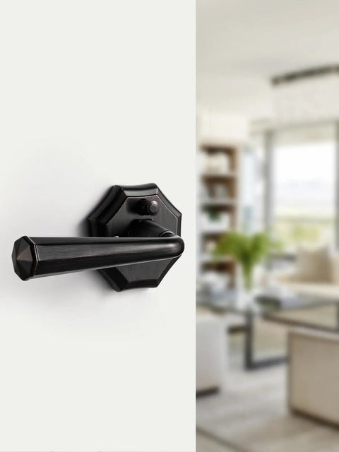 Close-up of oil rubbed bronze privacy door lever on interior door for bedroom, bathroom, closet, hallway with keyless inside thumb turn and emergency hex key access vintage style levers for easy locking and privacy.