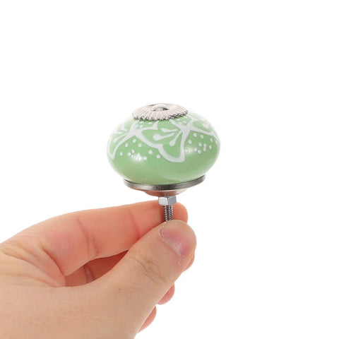 Top Shelf Vintage Floral Ceramic Cabinet Knobs And Drawer Pulls Set To Freshen Your Space With A Darn Cute 40mm Round Design, green floral knob held in hand.