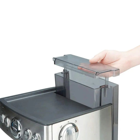 Pro Level Fully Automatic Espresso Coffee Machine Built For The Morning Rush With A Rock Solid 19 Bar Pump and a hand removing the water reservoir.