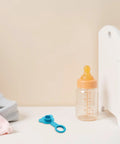 Blue Silicone Bathtub Plug Stopper for 1 Inch Drains beside baby bottle on a light background, showcasing bathroom accessory.