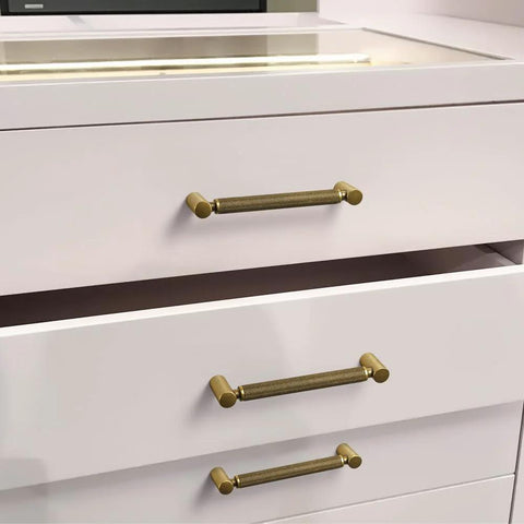Six Pack 5 Inch Center To Center Antique Brass Cabinet Pulls With Knurled Grip And Circular End Caps on white drawers