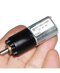 Badass 20mm Dc Micro Motor With 130 1 Planetary Gearbox And Knockout Slow Speed Control in a hand, showcasing compact size and gear design.