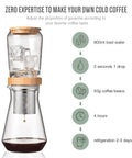 Top Shelf 800 Milliliter Glass Ice Drip Cold Brew Coffee Maker With Smooth Flow Filter Carafe showing coffee brewing process.