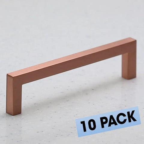 10 Pack Satin Copper Rose Gold Square Cabinet Hardware Euro Style Sleek Modern Bar Handle Pull 5 Inch Length 128 Mm Center To Center Includes 1 Inch And One And Five Eighths Inch Screws, shown on countertop, highlighting modern design.