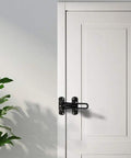 WUUWCHODC Sliding Door Bolt Lock for Gate Wooden Security Latch installed on a white door, featuring a black latch and a plant.