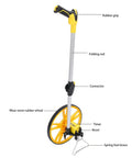 Solid No Fuss Hand Push Mechanical Measuring Wheel With Carry Pouch For Dead On Metric Tracking And Quick Rollouts On Job Sites Or Around The Yard, showing rubber grip, folding rod, and rubber wheel.