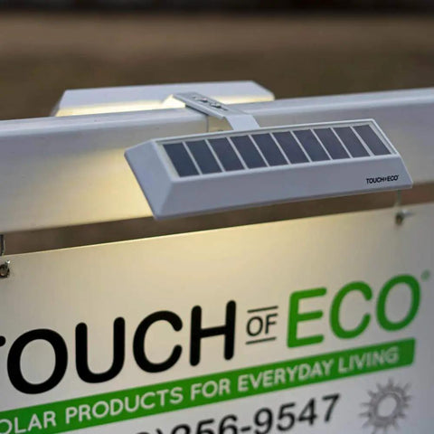 Solar Dual Sided LED Post Light illuminates sign for real estate, ultra bright and weather resistant, with mounting bracket.