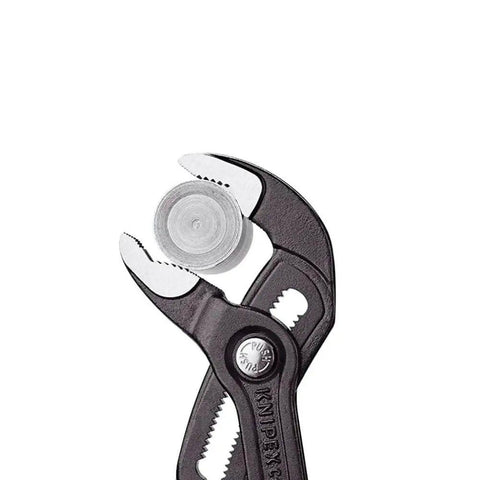Close-up of Heavy Duty 22 And A Half Inch Cobra Style Water Pump Pliers And Pipe Wrench with box joint holding nut.