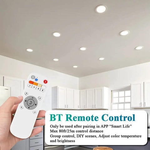 Person using remote to control 6 Inch Smart Recessed LED Can Lights with WiFi App and Remote in a modern kitchen ceiling.