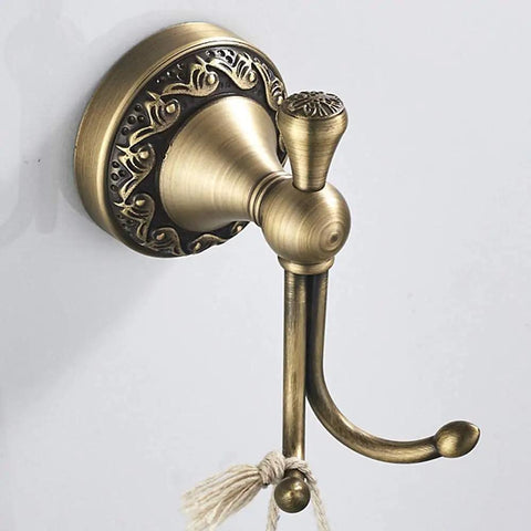 Antique Brass Bathroom Accessories 4 Piece Wave Pattern Wall Mount Set With Adjustable Towel Bar Extending From 16.7 To 29.1 Inches Towel Ring Toilet Paper Holder And Coat Hooks For A Retro Vintage Look - close-up of brass coat hook on white wall