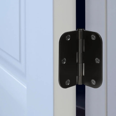 Close-up of Premium No Nonsense Matte Black Door Hinges 3.5 Inch installed on a door frame with screws visible.