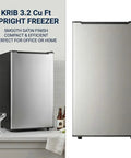 Spare Your Square Footage 3.2 Cubic Foot Upright Freezer In Classic Silver standing beside glasses and bottles on a kitchen countertop.