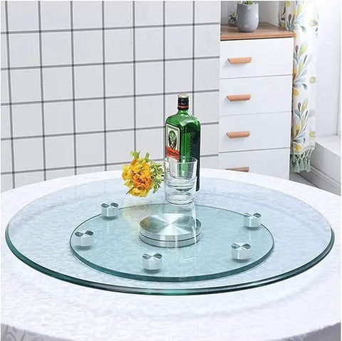 Clear Tempered Glass Lazy Susan Turntable with Silent Bearings and Six Smooth Rolling Wheels on a dining table.