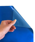 Hand holding corner of Electric Blue Siser EasyWeed Heat Transfer Vinyl Roll 11.8 Inch By 3 Feet for DIY Apparel