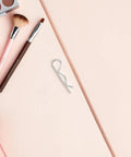 R Shape Cotter Pins That Totally Rock For Tough Mechanical Assembly Jobs Stainless Steel Lock Pin on a pink background with makeup tools