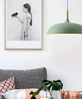 Modern Nordic Style Hanging Lamp Fixture Featuring Solid Wood Accents And Durable Iron Base Super Sleek Green Metal Shade in cozy living room.