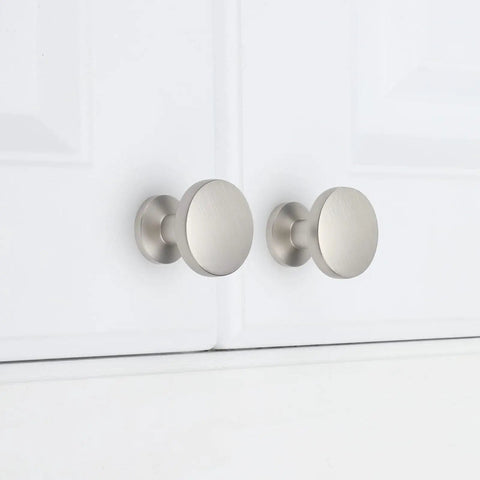 Brushed Nickel Cabinet Knobs Set 25 Pack Zinc Alloy Round Drawer Pulls mounted on white cabinet doors