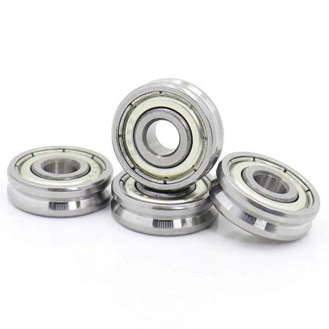 Top Shelf V Groove Sealed Ball Bearings With Badass Steel Core For Smooth Pulley Wheels And Guide Tracks Tough As Nails Precision Heavy Duty Four Pieces arranged showing shiny steel exterior and inner groove.