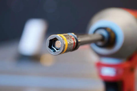 Close-up of Cleanable Reversible 4 Inch Magnetic Hex Chuck Driver With Dual Sided Magnetic Hex Bit attached to a power tool.