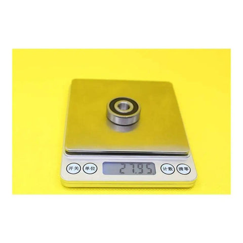 JANURSDHA 6200 Hybrid Ceramic Bearing Set 10x30x9mm ABEC-1 on scale weighing 27.95 grams for high speed motors.